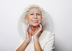 Grey haired old nice beautiful laughing woman. Isolated over vwhite background. Close up.