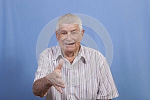 Grey haired senior male reaching out to shake hands