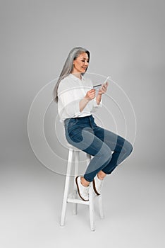 grey haired woman in jeans and