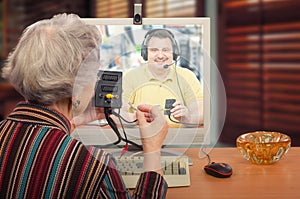 Grey haired woman learning computer peripherals photo