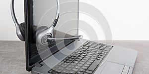 grey Headset with computer laptop on grey desk call center support and customer service