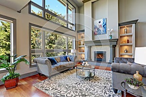 Grey interior of high vaulted ceiling family room.