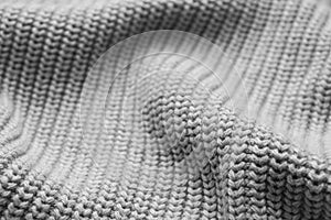 Grey knitted fabric as background, closeup view