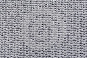 Grey knitted fabric as background, top view