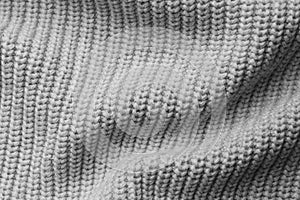 Grey knitted fabric as background, top view