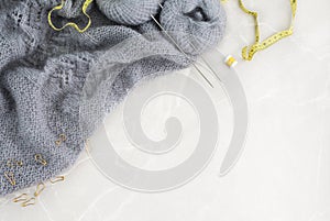 Grey knitwork on marble background