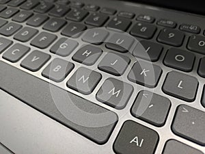 Grey laptop keyboard with AI key