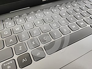 Grey laptop keyboard with AI key