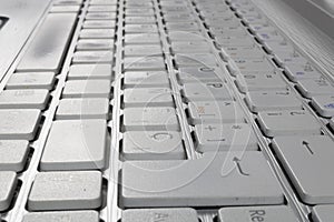 Grey laptop with white keyboard photo