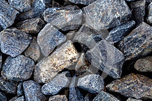Grey large gravel stones. Background with pile of granite rocks.