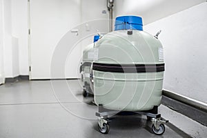 Grey liquid nitrogen tank storage with unmounted withdrawal device cryogenic hose.