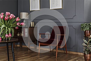 Grey living room interior with wainscoting on the wall, wooden c