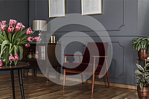 Grey living room interior with wainscoting on the wall, wooden c photo