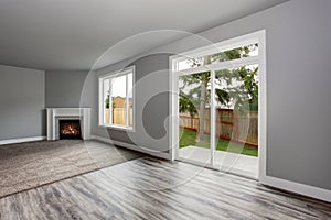 Grey living room interior. Windows and Glass doors overlooking the back yard.