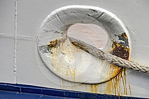 GRey marine rope through a ship`s hull