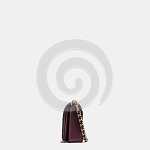 Grey and maroon small handbag with white background, Elegant maroon leather sling bag with golden chain and black sling with white