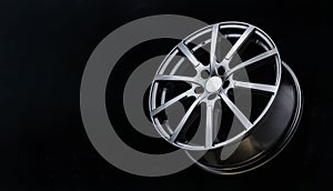 Grey Matt caluminum alloy wheel disc on black background. Sports a lot of spokes, copy space