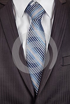 Grey men's business suit with a silk tie