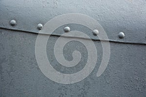 Grey metal background with rivets
