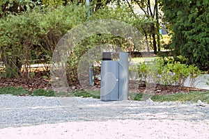 grey minimalist garbage can with mulched landscape in the park