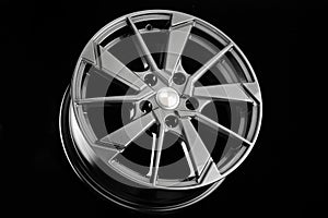 Grey modern cast disc alloy wheel on black background