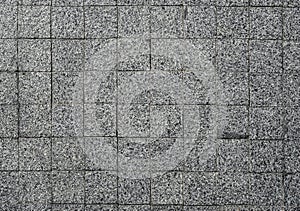 Grey modern coble stone background. Close up top view on monotone gray brick stone. Sidewalk or pavement