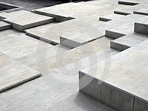 Grey modern geometric cubic concrete steps forming angular patterns and shapes