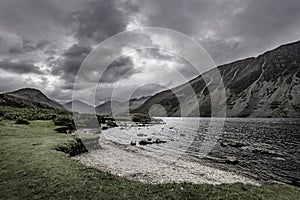 Grey, moody sky over scenic mountain valley with lake in Lake District,Cumbria,England