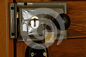 A grey mortise lock has a bakelite door knob, the key is in the key hole
