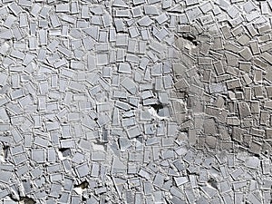 Grey Mosaic tiles on the wall of the house. Architectural abstract background texture. Gray concrete