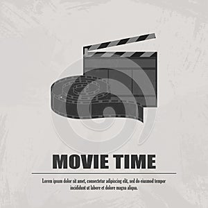 Grey movie clapboard with movi strip at light background