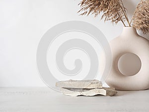 Grey natural stones podium on white background, platform for product display