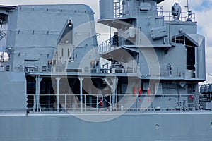 Grey navy battleship in a port in summertime