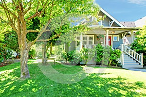 Grey old American house with summer landscape.