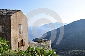 Grey old house with the sea and hills in background, Alonissos island