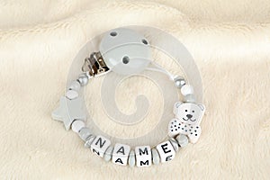 A grey pacifier chain