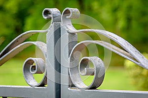 Grey painted forged metal gate.