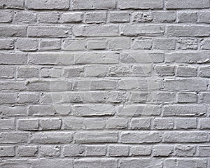Grey painted horizontal part of brick wall