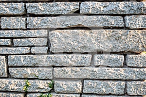 Grey pattern rock wall with sunlight for background