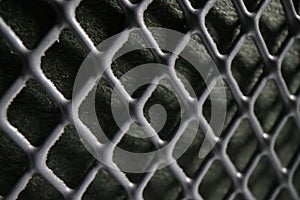 Grey perforated metal mesh as abstract industrial background