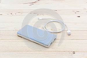 Grey powerbank and USB cable for smartphone.