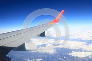 Grey and red wing of plain in sky