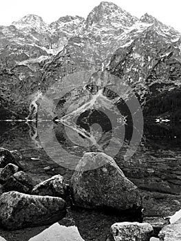 A grey reflection of the stones of Morskie Oko - Poland - Tatra National Park in the Rybi Potok Valley