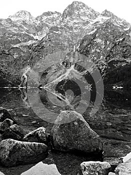 A grey reflection of the stones of Morskie Oko - Poland - Tatra National Park in the Rybi Potok Valley photo