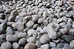 Grey river pebbels in a large space