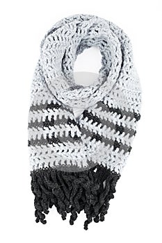 Grey scarf of handwork knitted by a hook on a white background