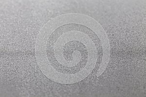Grey silver metallic glitter shiny modern cold industrial textured background selective focus