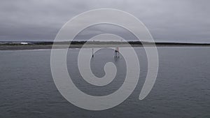 Grey Skies Overhead: Navigational Markers at Washington\'s Coastal Inlet