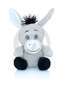 Grey smiling donkey plushie toy isolated on white background with shadow reflection. African wild plaything.