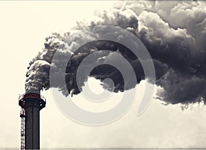 Grey smoking industrial two chimneys